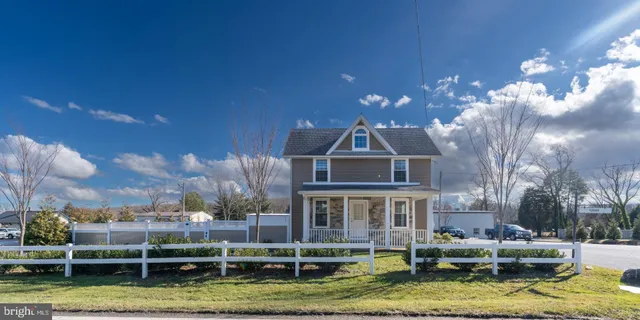 a front view of a house with a yard large swimming pool and outdoor seating