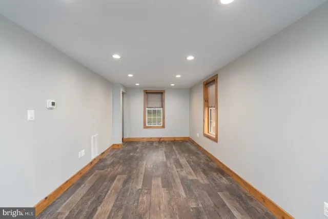 a view of room with window and wooden floor