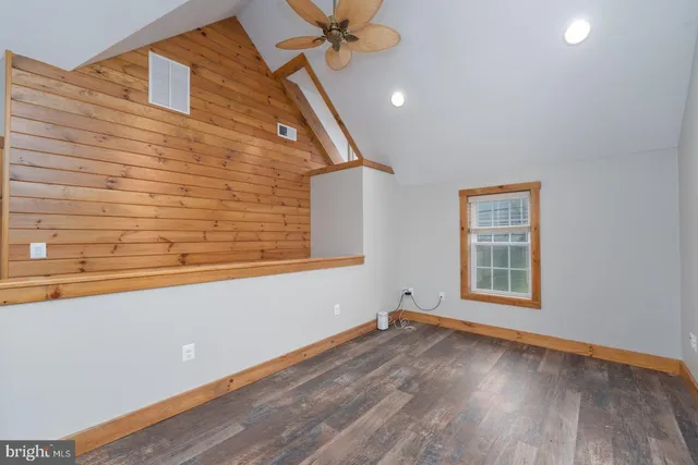 a view of a livingroom with wooden floor and a window