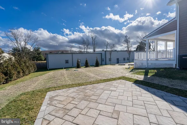 a view of a house next to a road and a yard