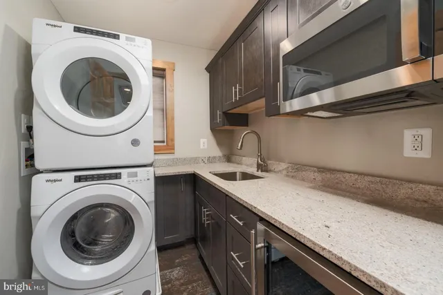 a utility room with sink dryer and washer