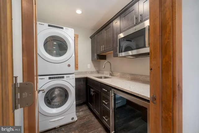 a utility room with sink dryer and washer