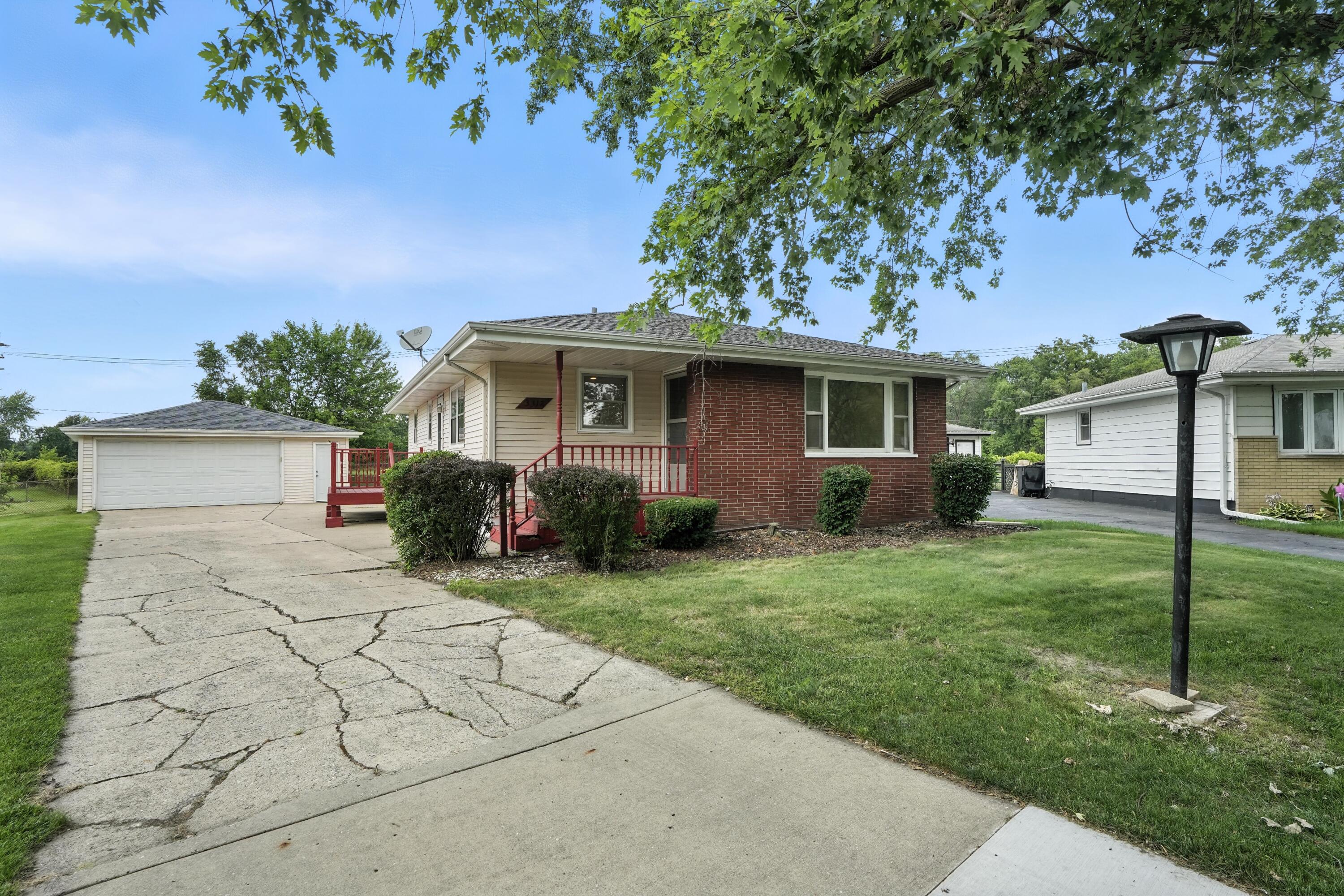 3312 East 170th Street Lansing, IL 60438 - Photo 2 of 38 a front view of a house with garden