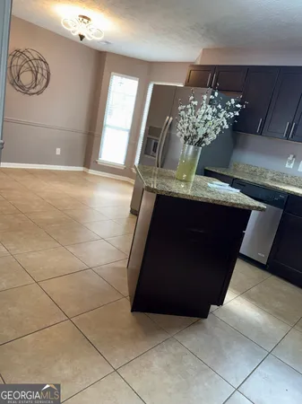 a kitchen with a sink a counter top space and cabinets