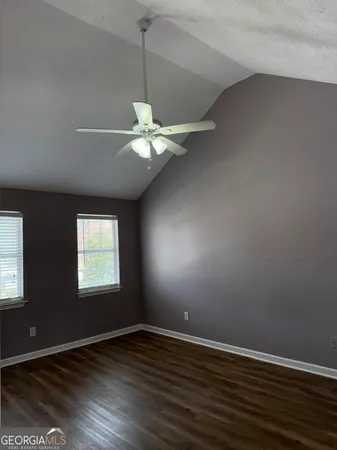 a view of room with wooden floor and flat screen tv