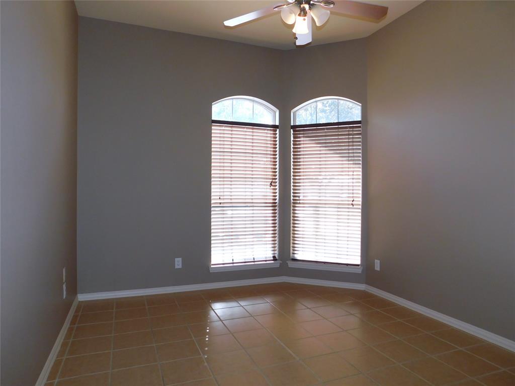 3919 Canton Court Denton, TX 76208 - Photo 19 of 26 an empty room with chandelier fan and windows