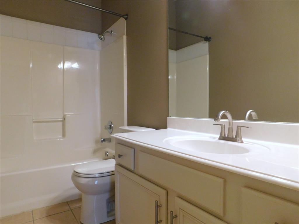 3919 Canton Court Denton, TX 76208 - Photo 22 of 26 a bathroom with a sink a toilet and shower