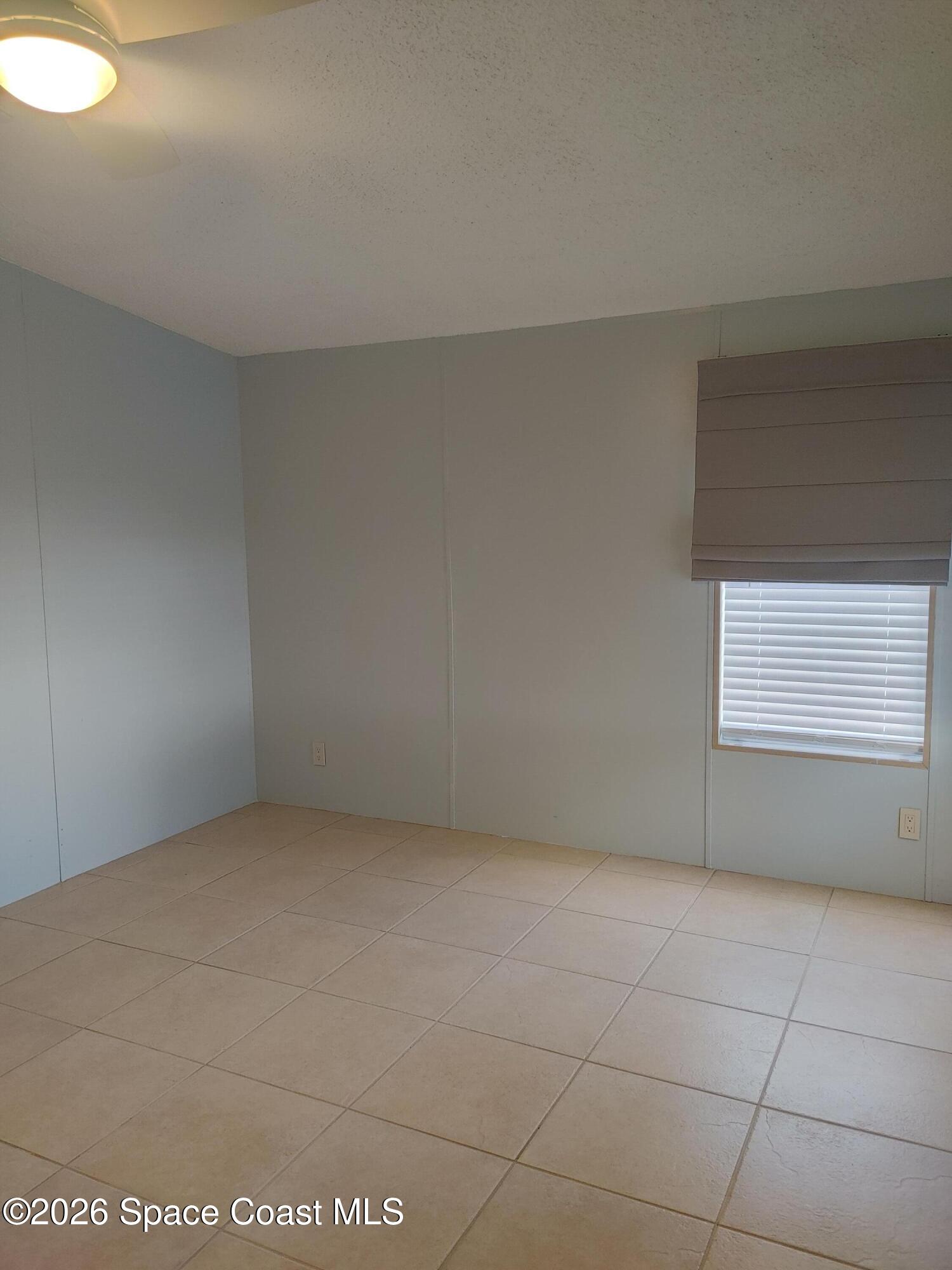 7629 Chasta Road Micco, FL 32976 - Photo 11 of 16 a view of an empty room and window