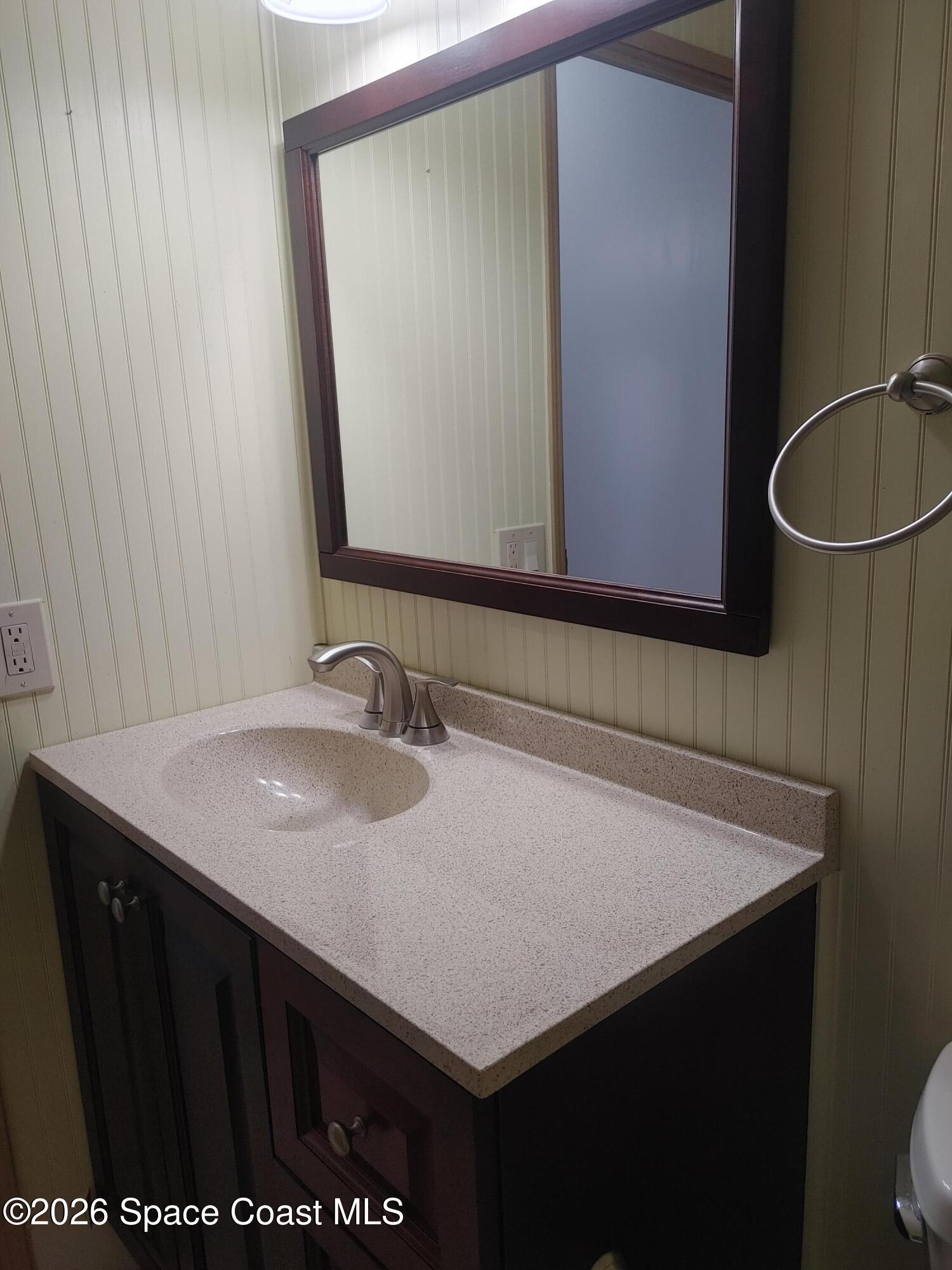 7629 Chasta Road Micco, FL 32976 - Photo 12 of 16 a bathroom with a sink a mirror and a toilet