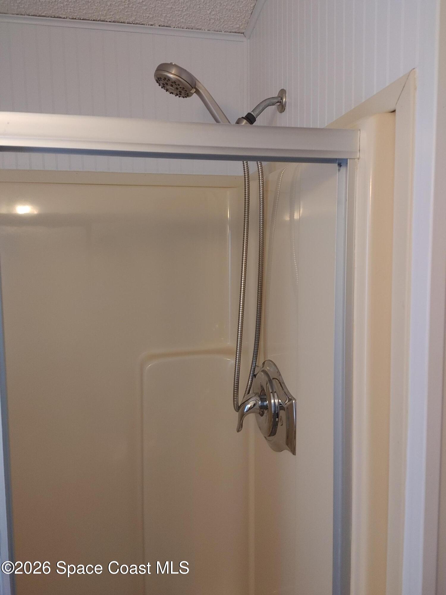 7629 Chasta Road Micco, FL 32976 - Photo 15 of 16 a bathroom with a glass shower door