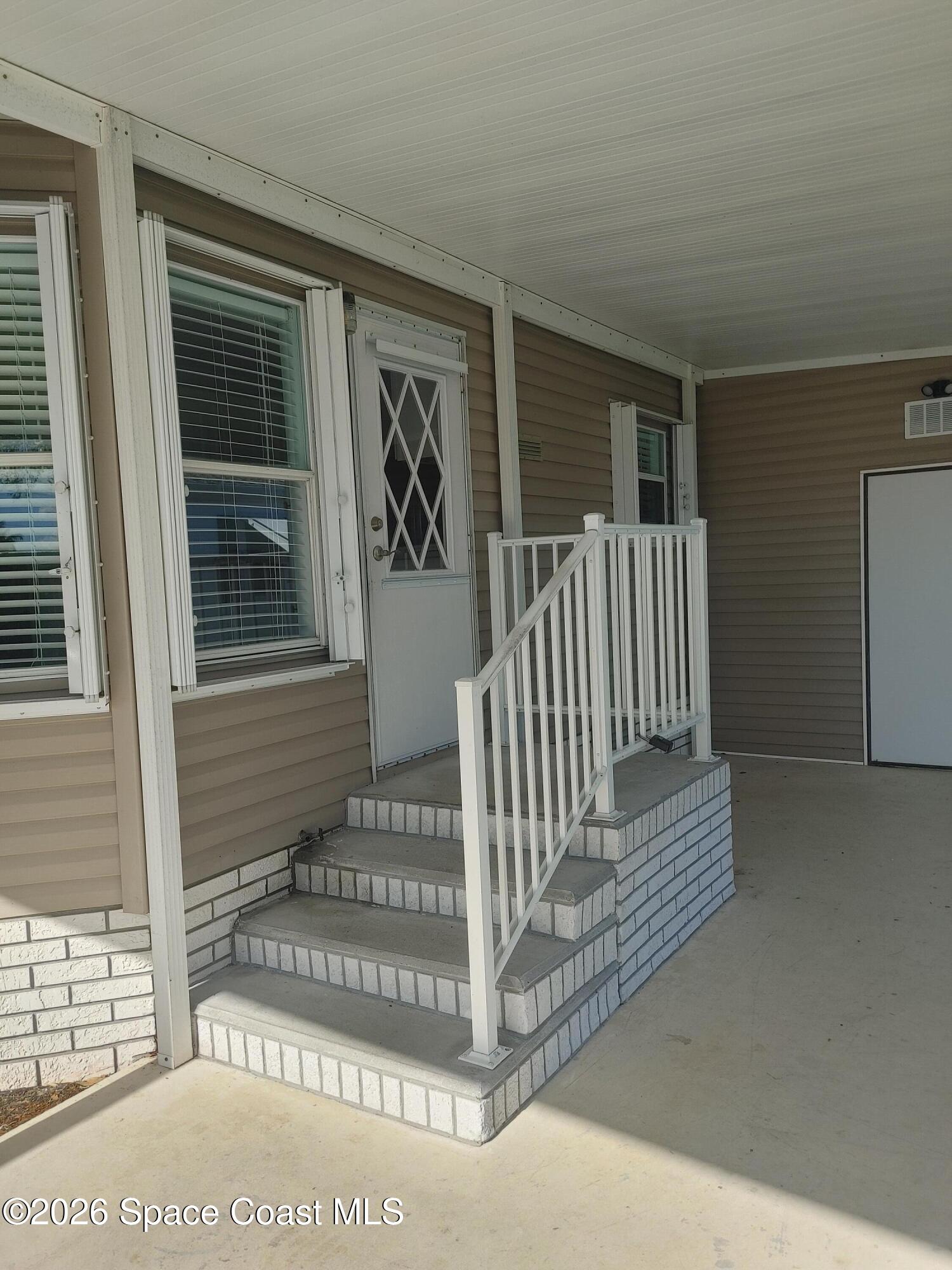 7629 Chasta Road Micco, FL 32976 - Photo 2 of 16 a view of a house with wooden floor and fence