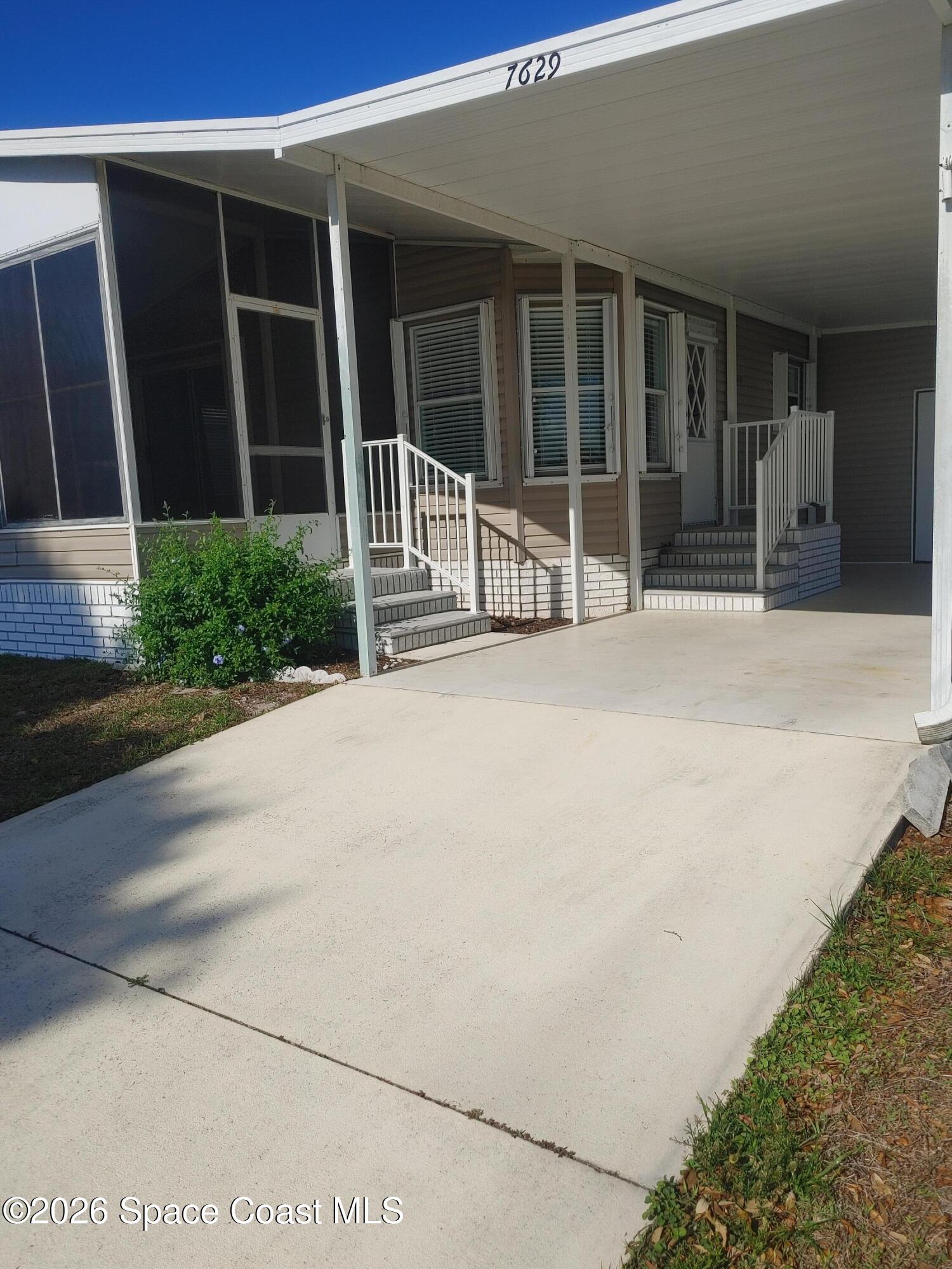 7629 Chasta Road Micco, FL 32976 - Photo 3 of 16 front view of a house with a outdoor space