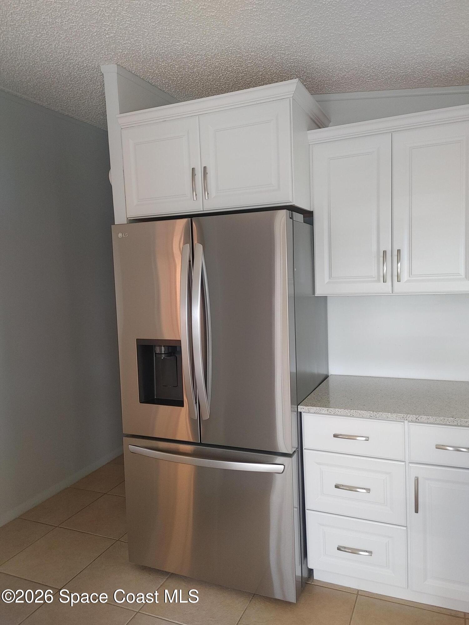 7629 Chasta Road Micco, FL 32976 - Photo 3 of 16 a white refrigerator freezer sitting in a kitchen