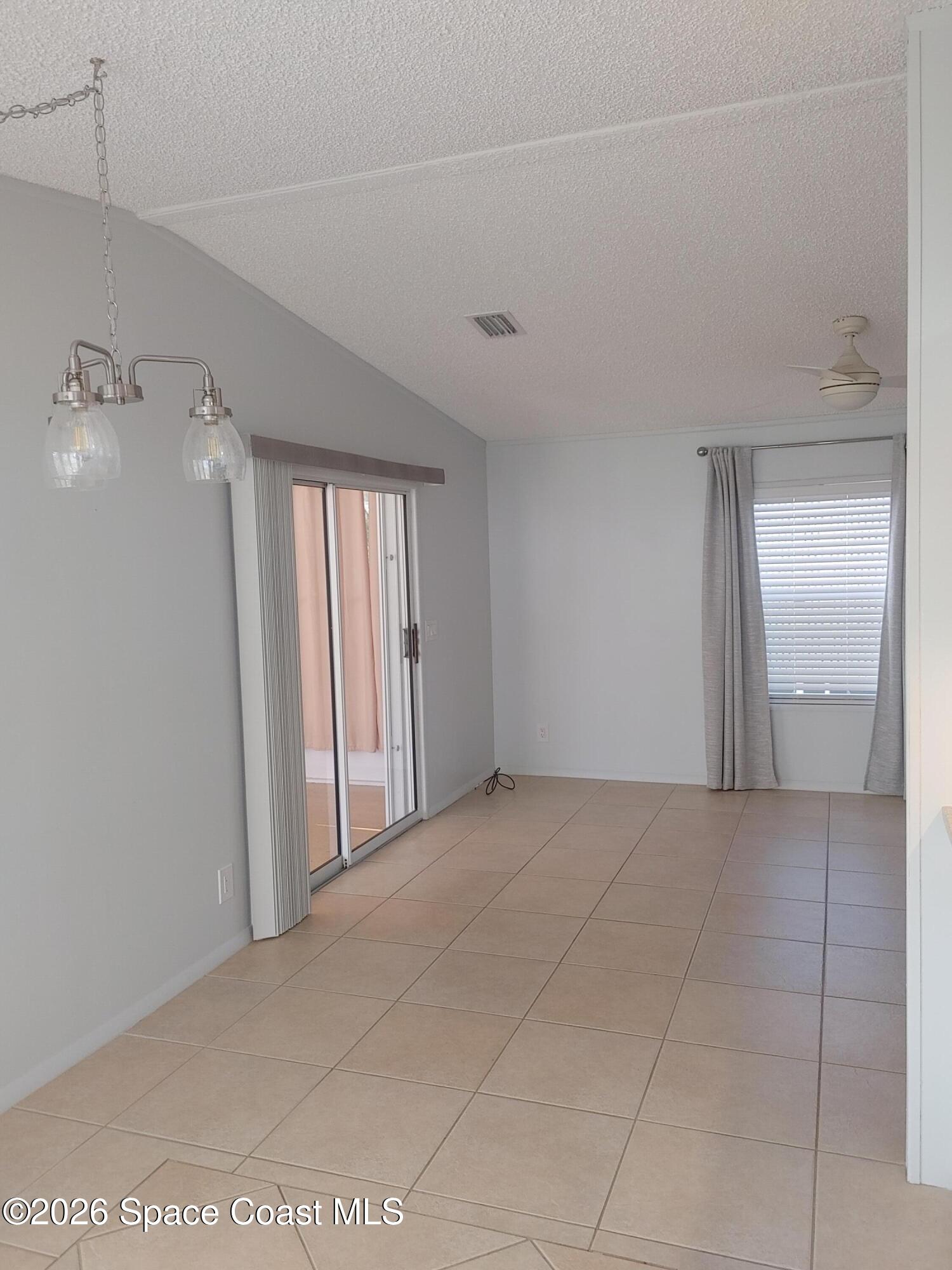 7629 Chasta Road Micco, FL 32976 - Photo 8 of 16 a view of a livingroom with an empty space and a window