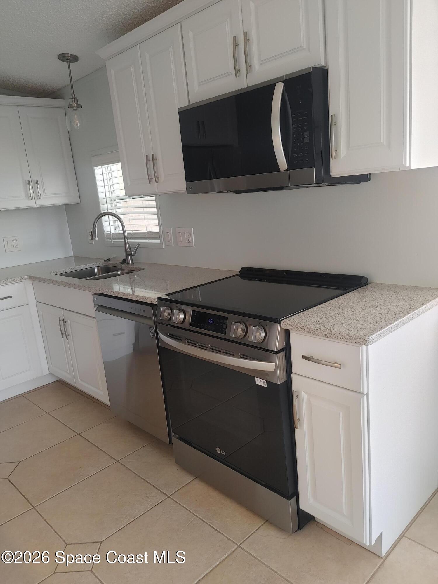 7629 Chasta Road Micco, FL 32976 - Photo 9 of 16 a kitchen with granite countertop a stove and a sink