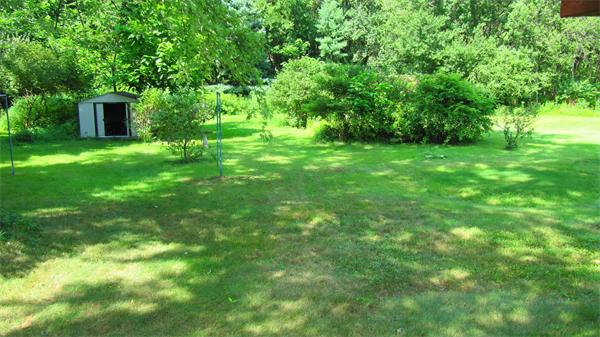 18 Robin Road Westborough, MA 01581 - Photo 13 of 15 a view of a backyard with table and chairs and wooden fence