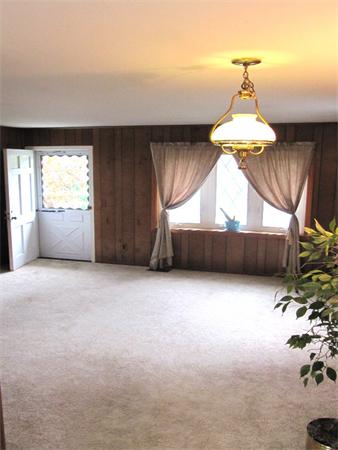 18 Robin Road Westborough, MA 01581 - Photo 5 of 15 en empty room with a window and chandelier