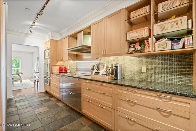 a kitchen with stainless steel appliances granite countertop a sink and cabinets