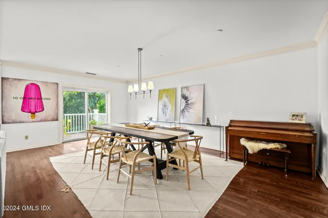 a view of a dining room with furniture window and wooden floor