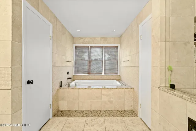 a bathroom with a granite countertop sink a toilet and shower