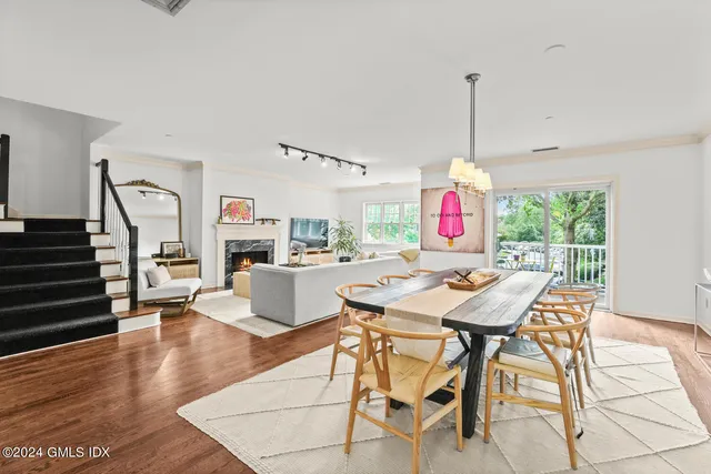 a dining room with furniture and wooden floor