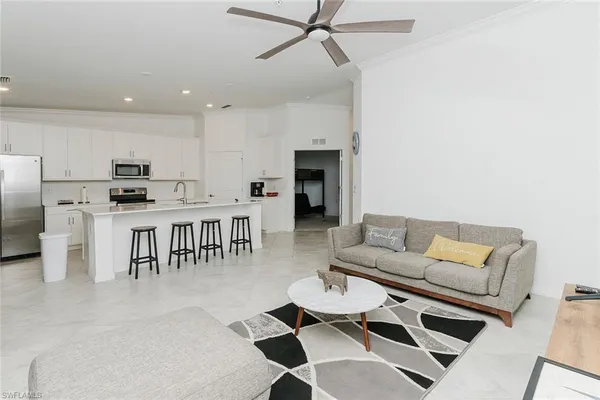 a living room with furniture and kitchen view