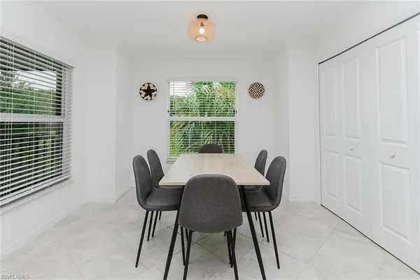 a view of a dining room with furniture and a window