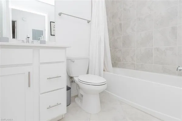 a bathroom with a toilet sink and shower