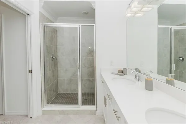 a bathroom with a shower a sink and mirror