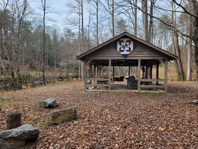 a view of a backyard with table and chairs