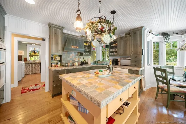 a kitchen with stainless steel appliances kitchen island granite countertop a refrigerator and stove