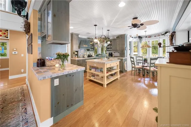 an outdoor living room with furniture and a floor to ceiling window