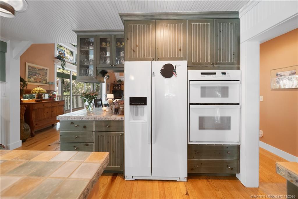 12 Oak Hill Way Stuart, FL 34996 - Photo 17 of 63 a kitchen with stainless steel appliances kitchen island granite countertop a refrigerator and stove
