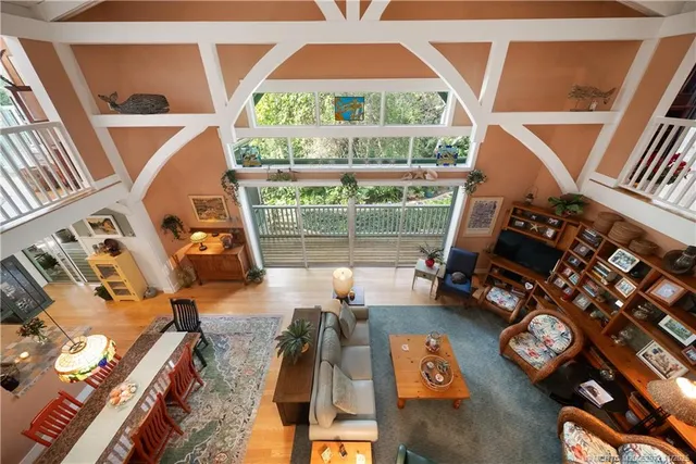 a living room with furniture a fireplace and a large window