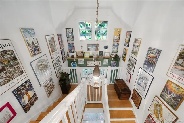 a bed sitting in a spacious bedroom next to a large window