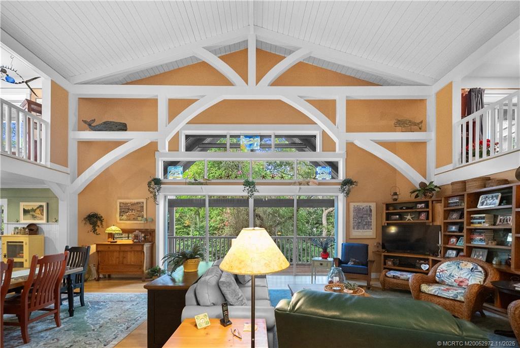 12 Oak Hill Way Stuart, FL 34996 - Photo 25 of 63 a living room with furniture a fireplace and a large window