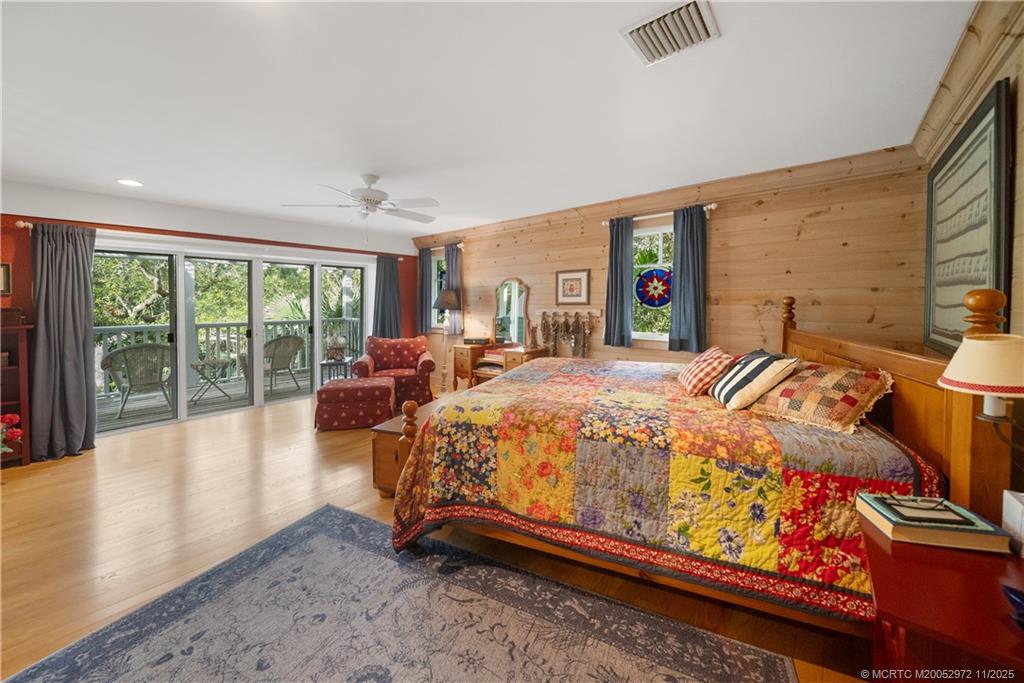 12 Oak Hill Way Stuart, FL 34996 - Photo 29 of 63 a bed sitting in a spacious bedroom next to a large window