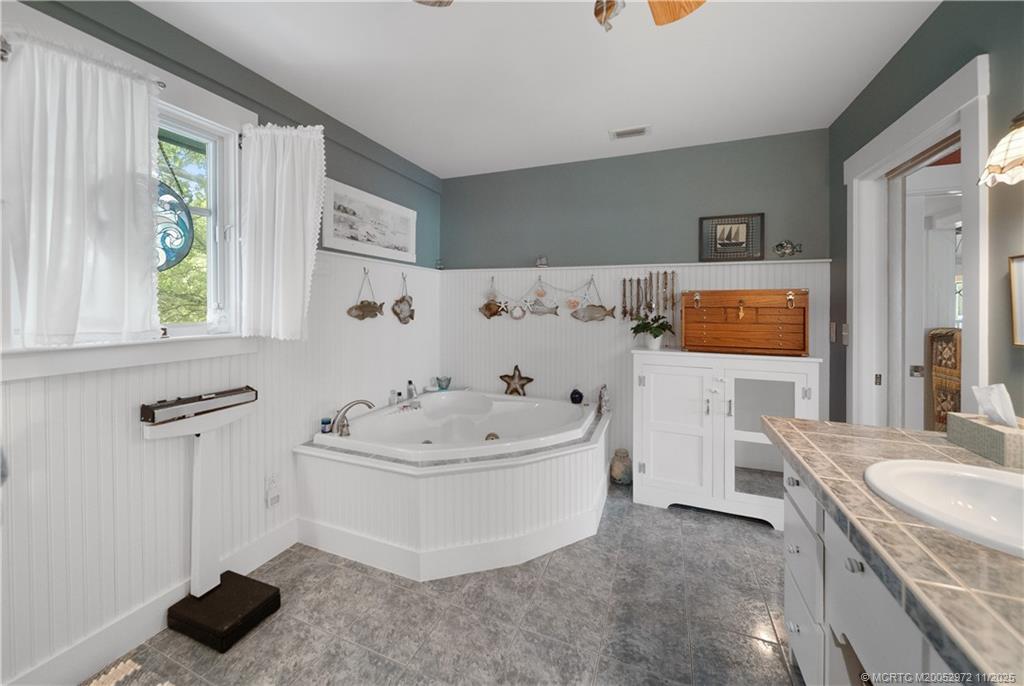 12 Oak Hill Way Stuart, FL 34996 - Photo 31 of 63 a spacious bathroom with a tub sink and mirror