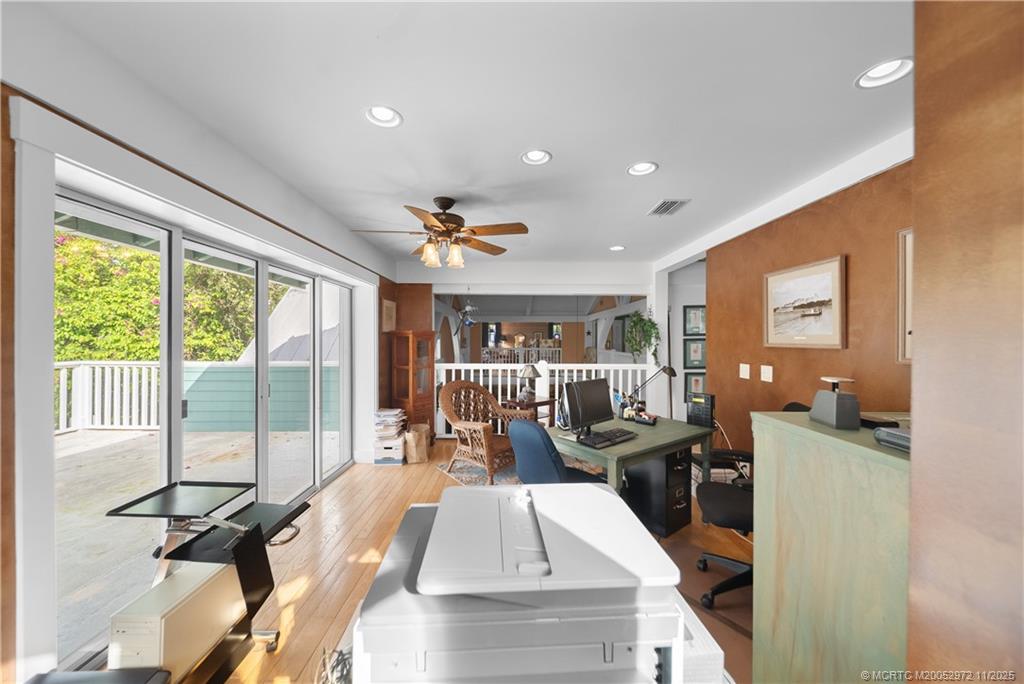 12 Oak Hill Way Stuart, FL 34996 - Photo 36 of 63 a view of a living room and kitchen floor to ceiling windows