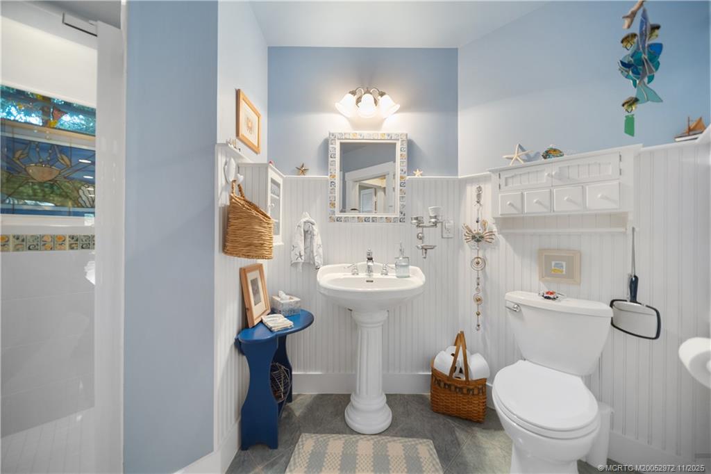 12 Oak Hill Way Stuart, FL 34996 - Photo 46 of 63 a white toilet sitting next to a bathroom sink and a tub