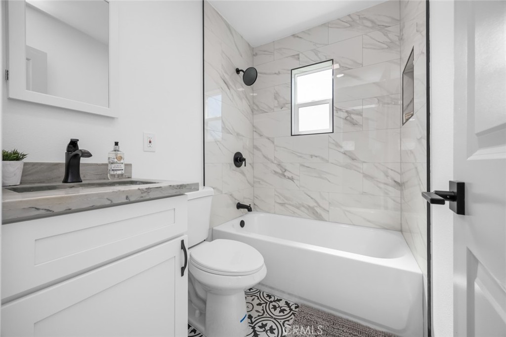 201 South Melrose Street Placentia, CA 92870 - Photo 29 of 35 a bathroom with a granite countertop toilet a sink and a bathtub