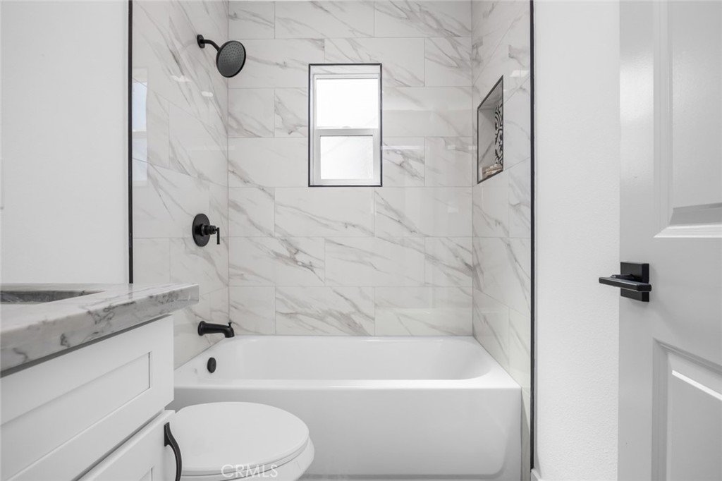 201 South Melrose Street Placentia, CA 92870 - Photo 30 of 35 a bathroom with a granite countertop bathtub shower sink vanity and toilet