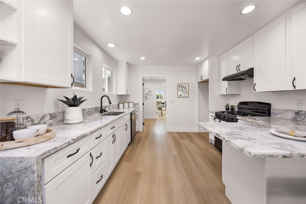 201 South Melrose Street Placentia, CA 92870 - Photo 3 of 35 a large kitchen with stainless steel appliances granite countertop a lot of counter space and wooden floors