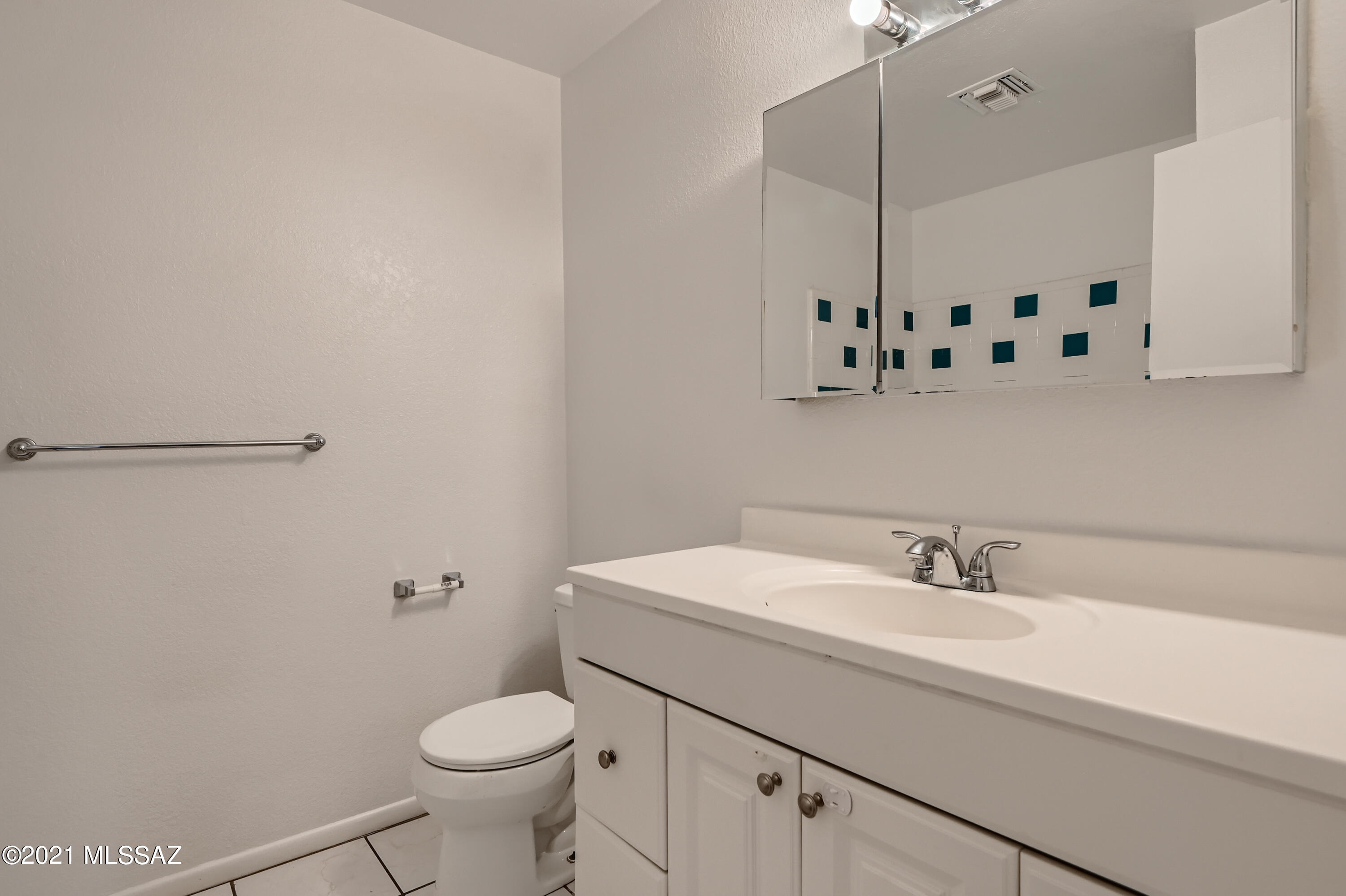 10681 Keystone Road East Tucson, AZ 85730 - Photo 25 of 33 a bathroom with a sink a toilet and mirror