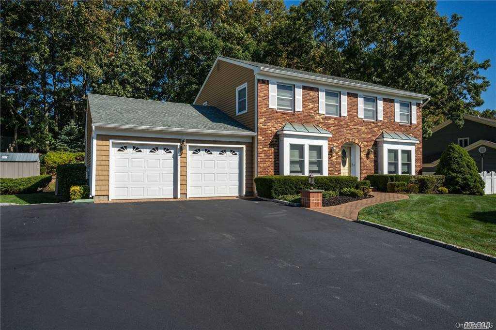 52 Timber Ridge Drive Commack, NY 11725 - Photo 1 of 1 a front view of a house with a yard and garage