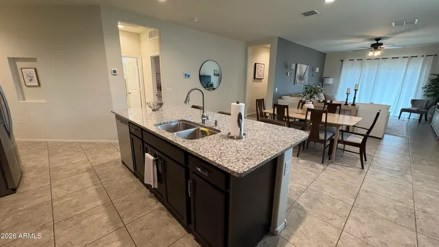 a large bed sitting in a bedroom next to a window and potted plant