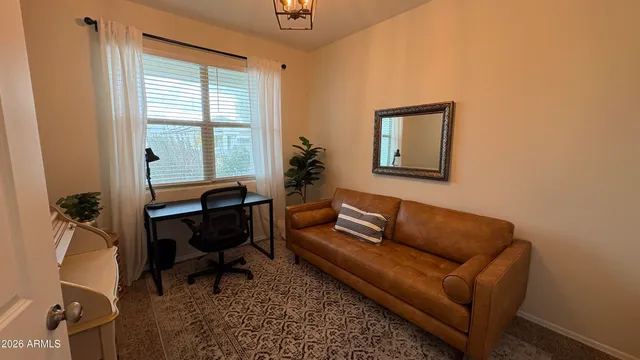 a bedroom with a bed and a chair