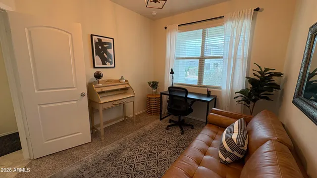 a bedroom with a bed and a painting on the wall