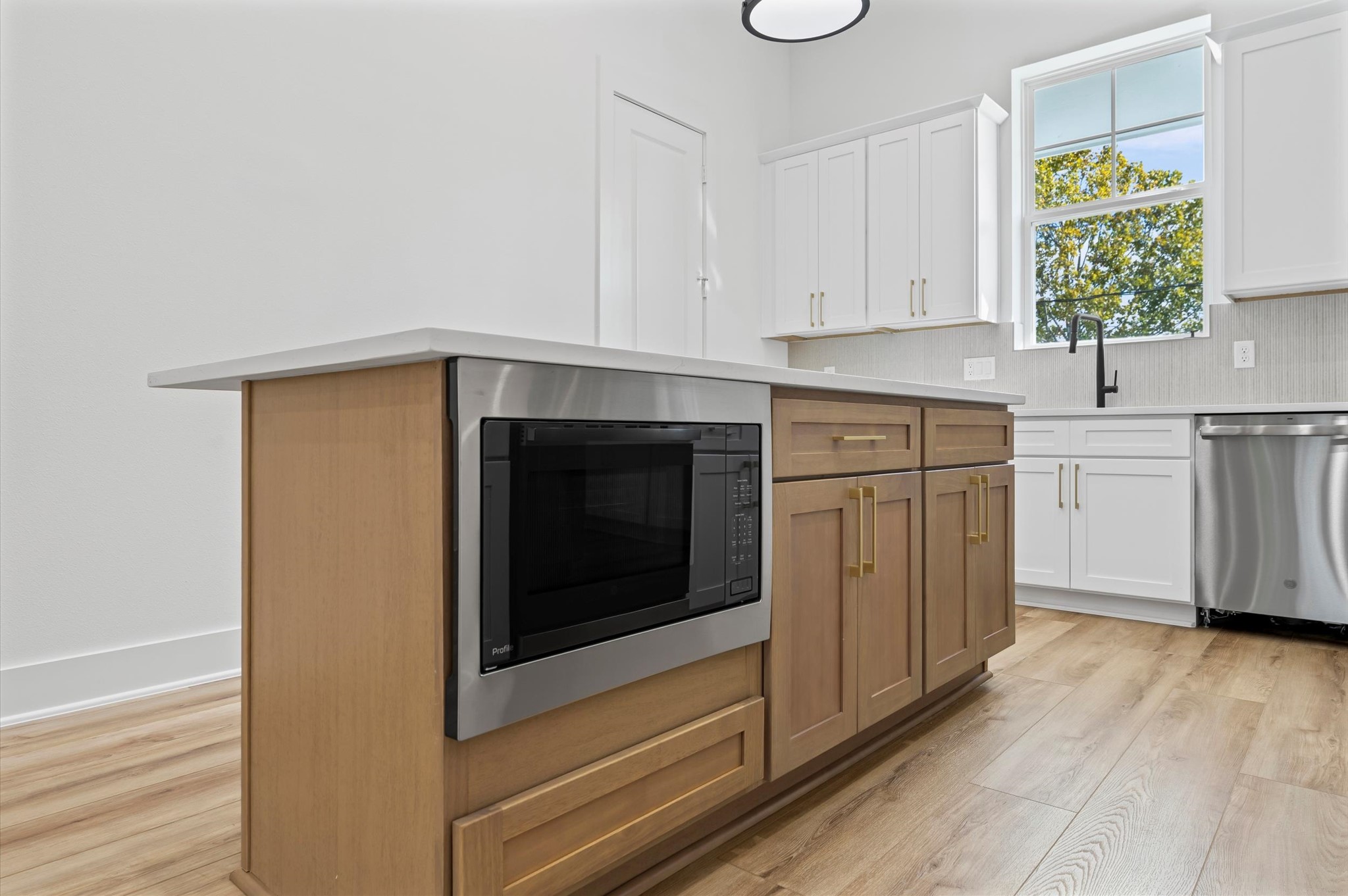 4129 De George Street Houston, TX 77009 - Photo 18 of 46 a kitchen with stainless steel appliances white cabinets and a stove top oven