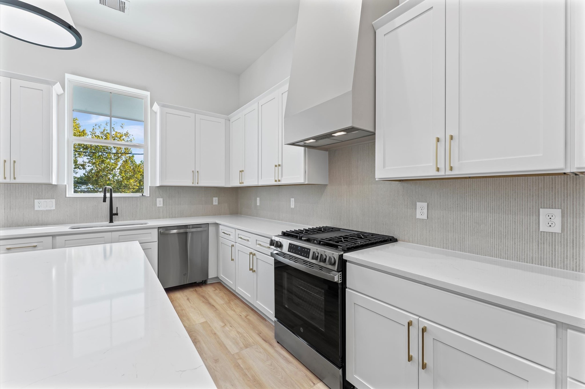 4129 De George Street Houston, TX 77009 - Photo 19 of 46 a kitchen with stainless steel appliances granite countertop white cabinets granite counter tops and a hard wood floors